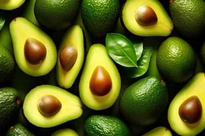 Fresh Ripe Avocados Arranged On A Green Background
