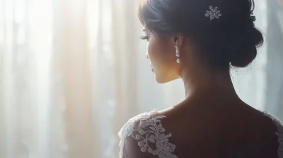 Elegant Bride Looking Out A Window In Soft Light