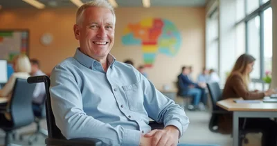 Smiling Mature Man In Wheelchair At Modern Office