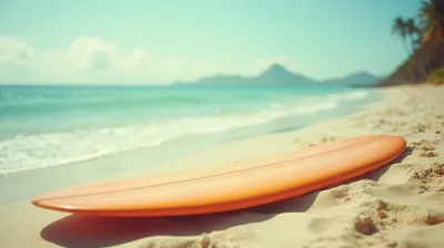 Orange Surfboard Resting On A Tropical Sandy Beach