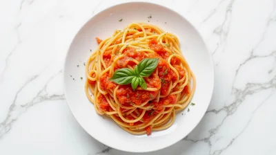 Spaghetti Pomodoro with Fresh Basil on Marble Surface
