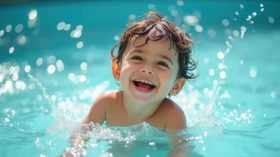 Happy Toddler Boy Playing In Swimming Pool