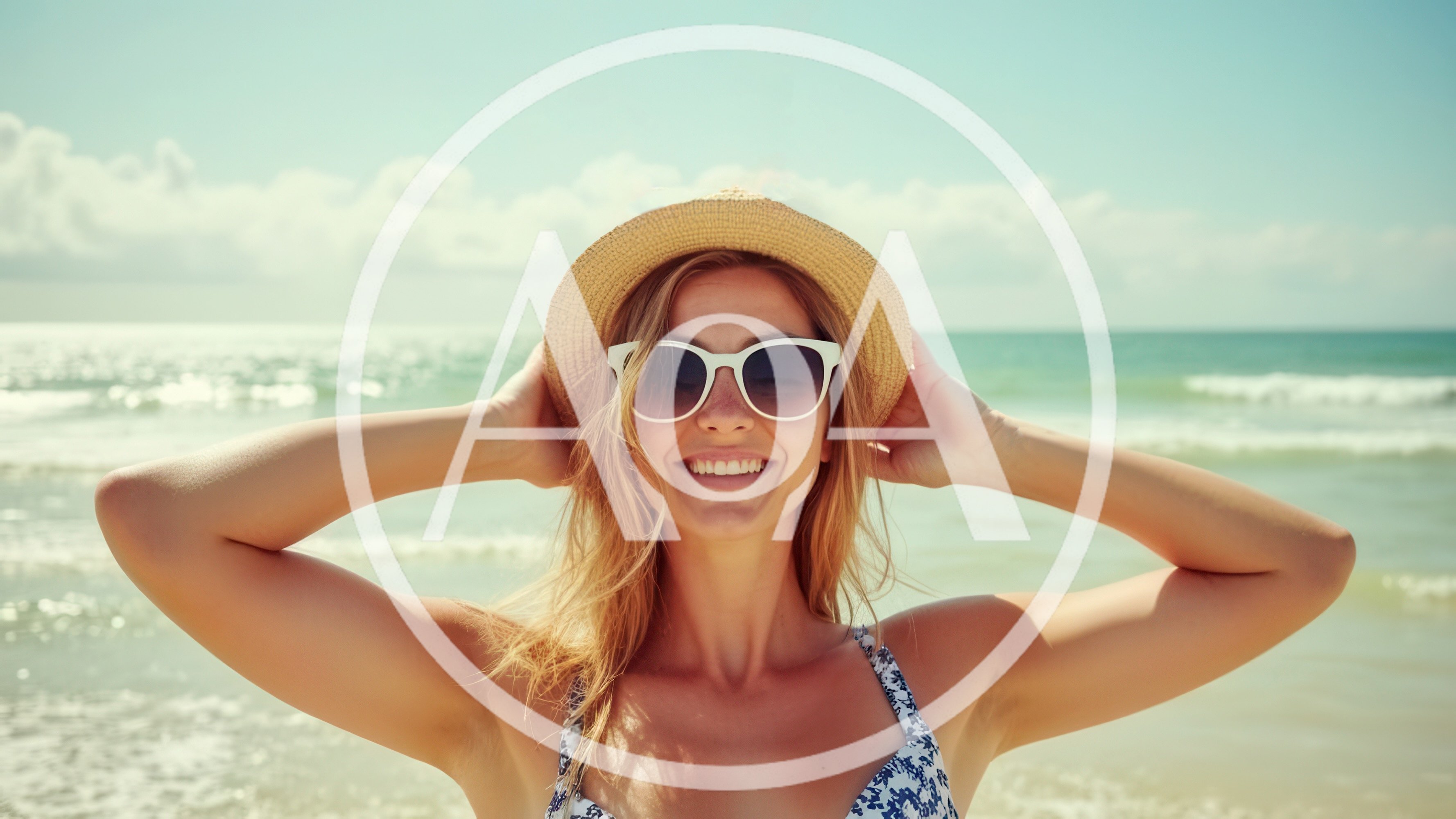 Smiling Woman Wearing Straw Hat and Sunglasses at Beach