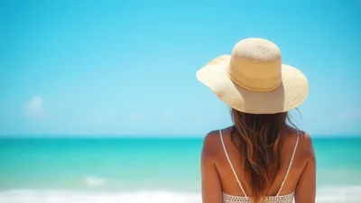Woman Wearing Sun Hat Looking At Tropical Ocean