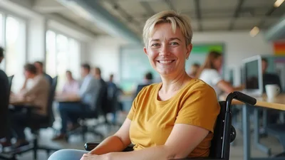 Smiling Woman In Wheelchair Working In Modern Office