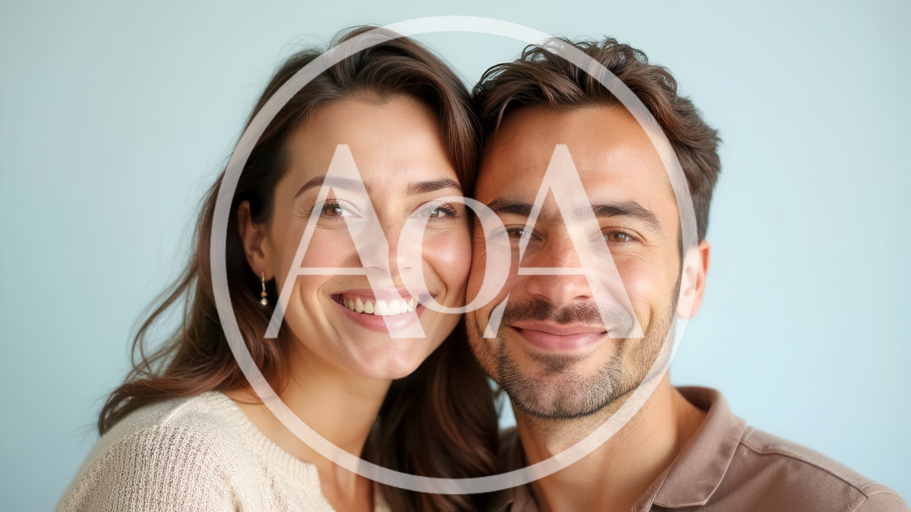 Happy Couple Smiling Together Against A Light Blue Background