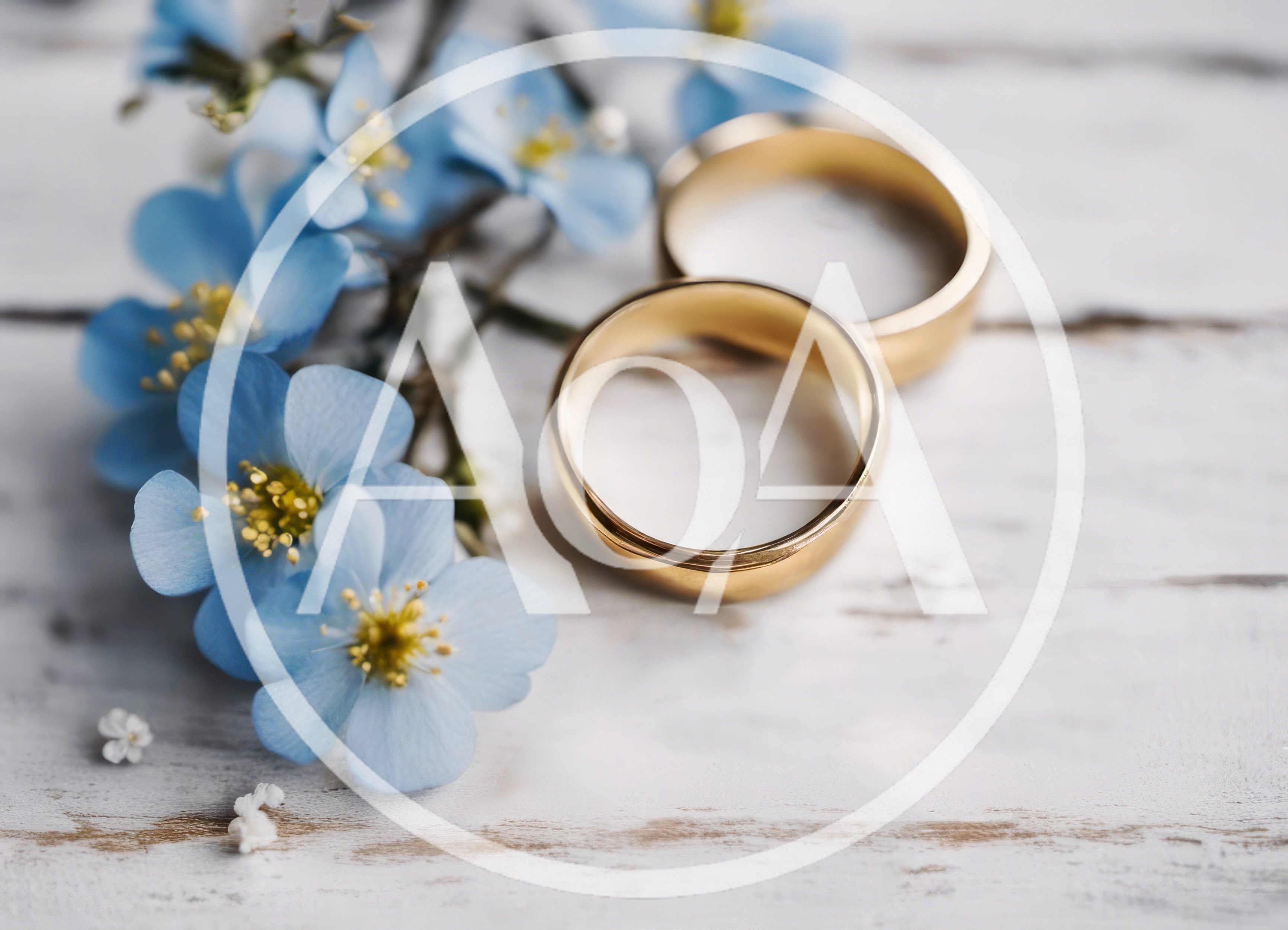 Two Gold Wedding Rings With Blue Flowers