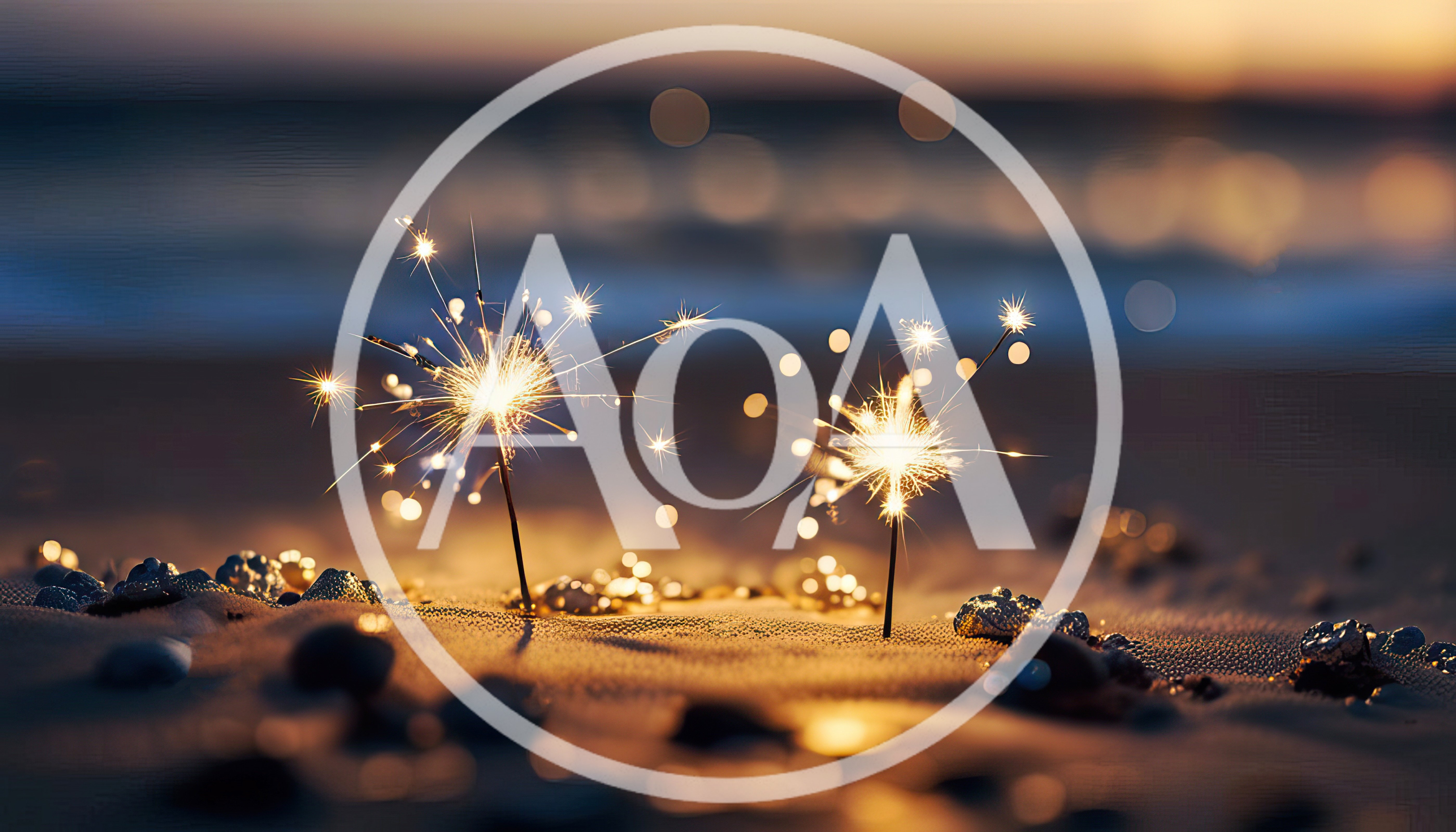 Two Burning Sparklers On A Sandy Beach At Sunset