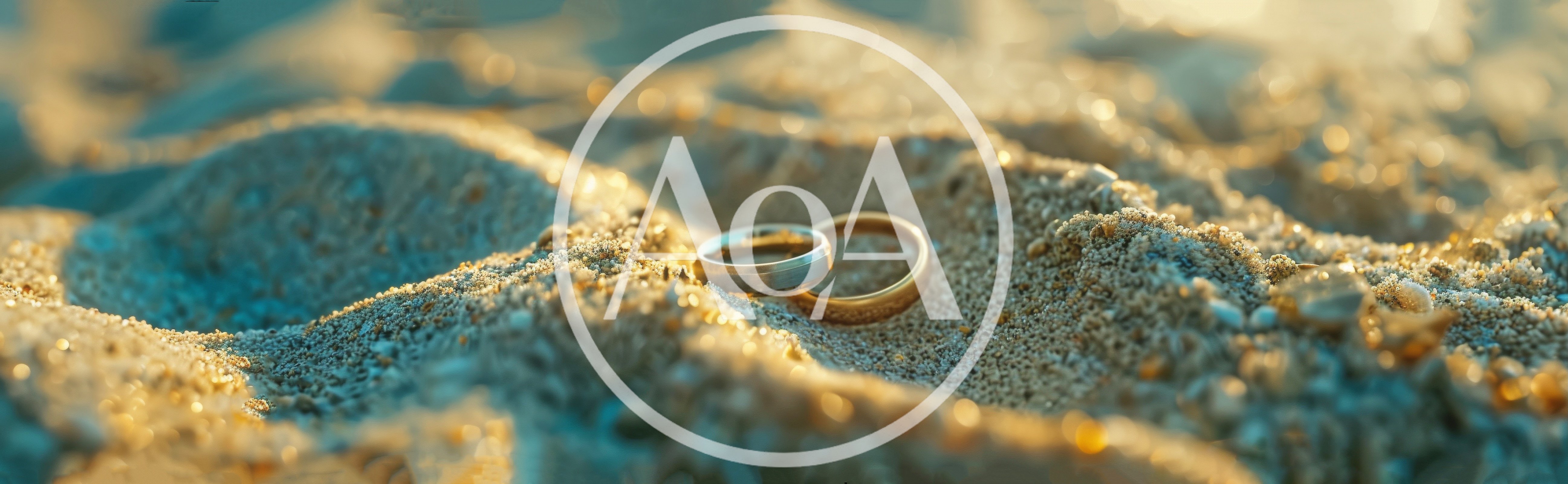 Two Wedding Rings Resting On Sandy Beach