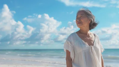 Senior Asian Woman Enjoying A Sunny Beach Day
