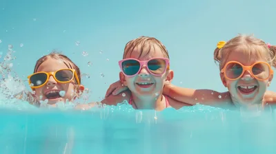 Three Happy Children Playing in Swimming Pool