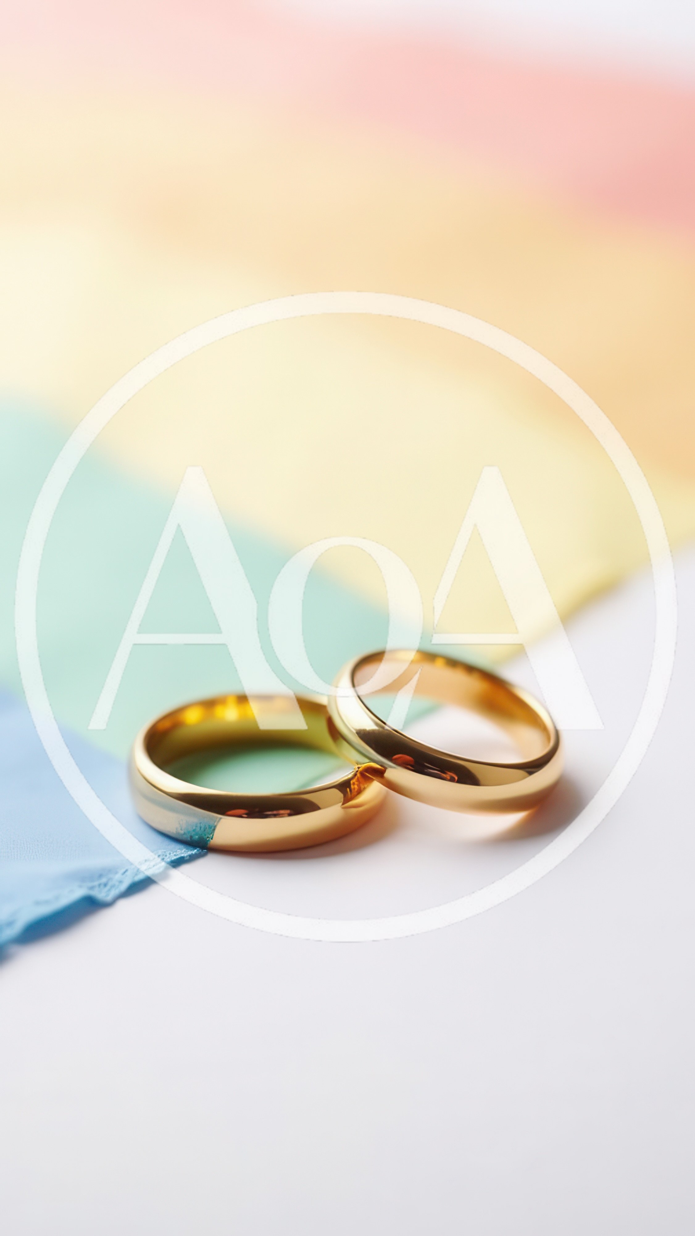 Two Gold Wedding Rings On A Rainbow Pride Flag