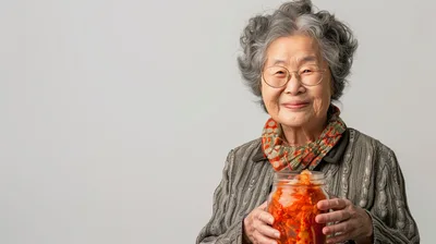 Elderly Asian Woman Holding A Jar Of Kimchi