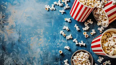 Popcorn Buckets and Scattered Kernels on Blue Background