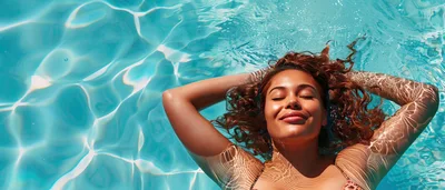 Woman Relaxing In Swimming Pool Water