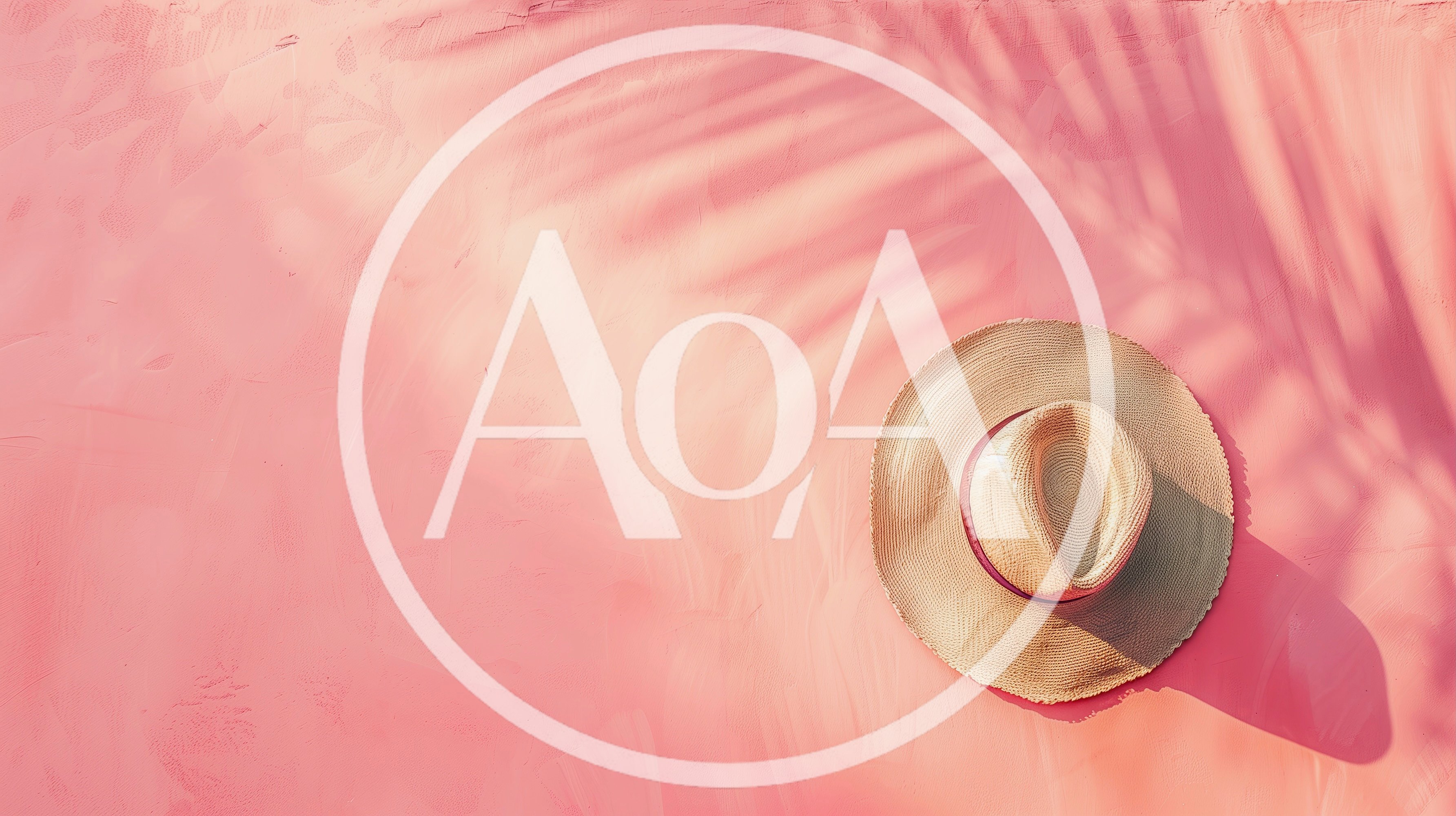 Straw Sun Hat on Pink Textured Background