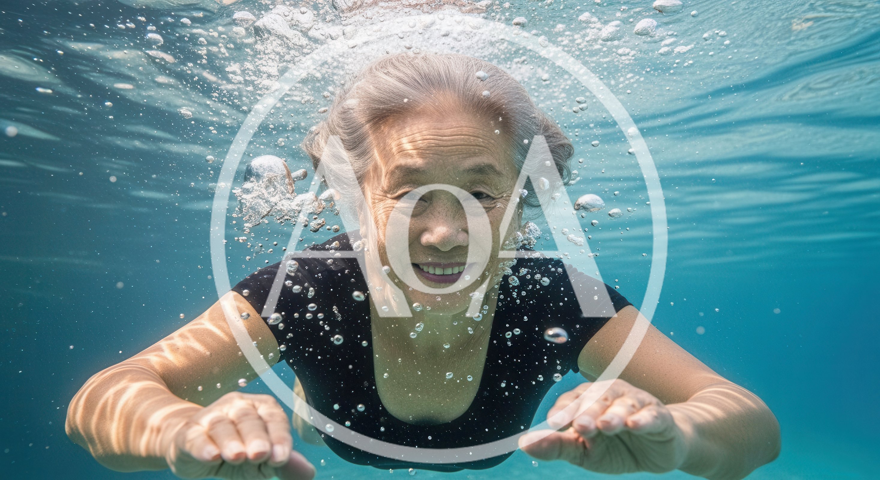 Senior Asian Woman Swimming Underwater In Clear Blue Water