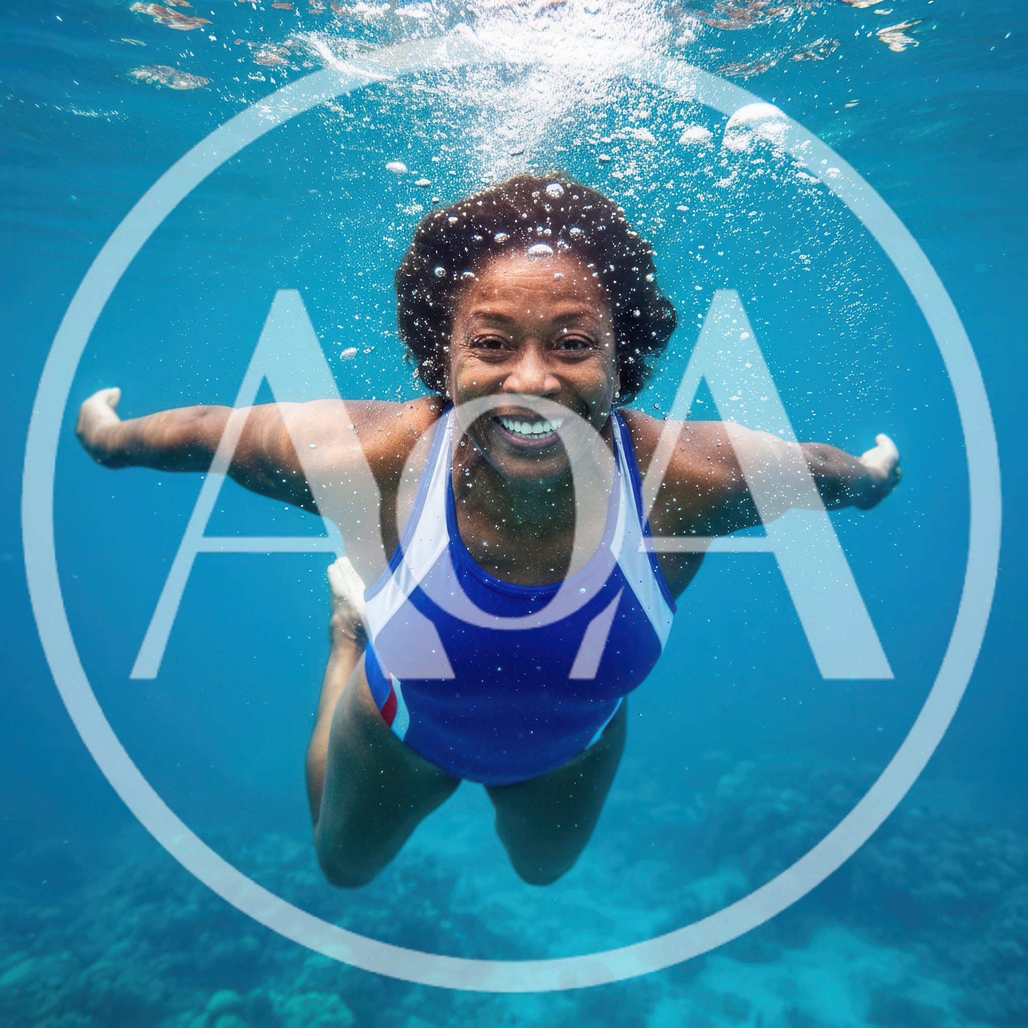 Happy Mature Woman Swimming Underwater In The Ocean
