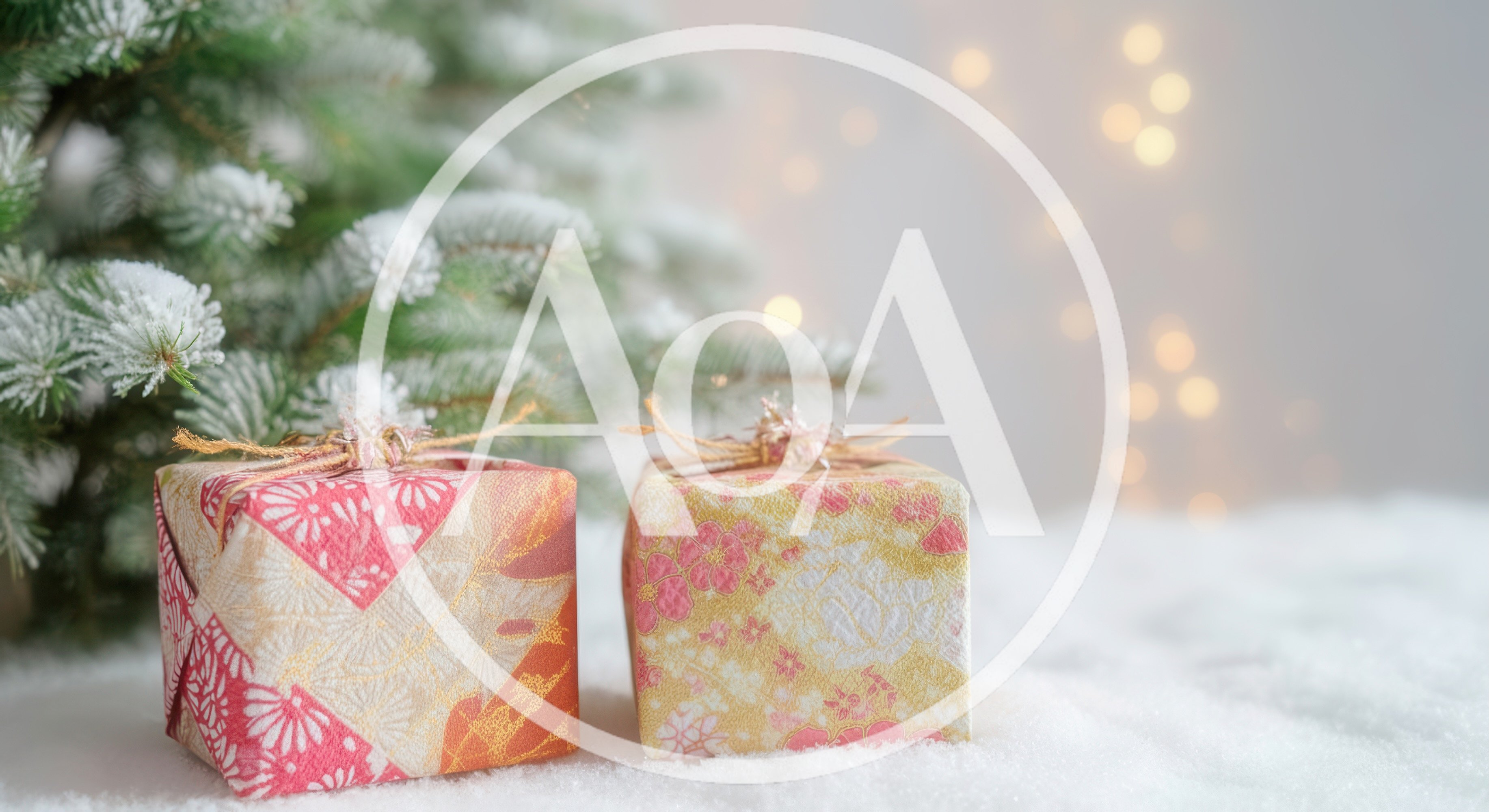 Two Decorative Christmas Gift Boxes Under Snowy Tree