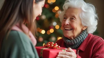 Granddaughter Giving Christmas Gift To Grandmother