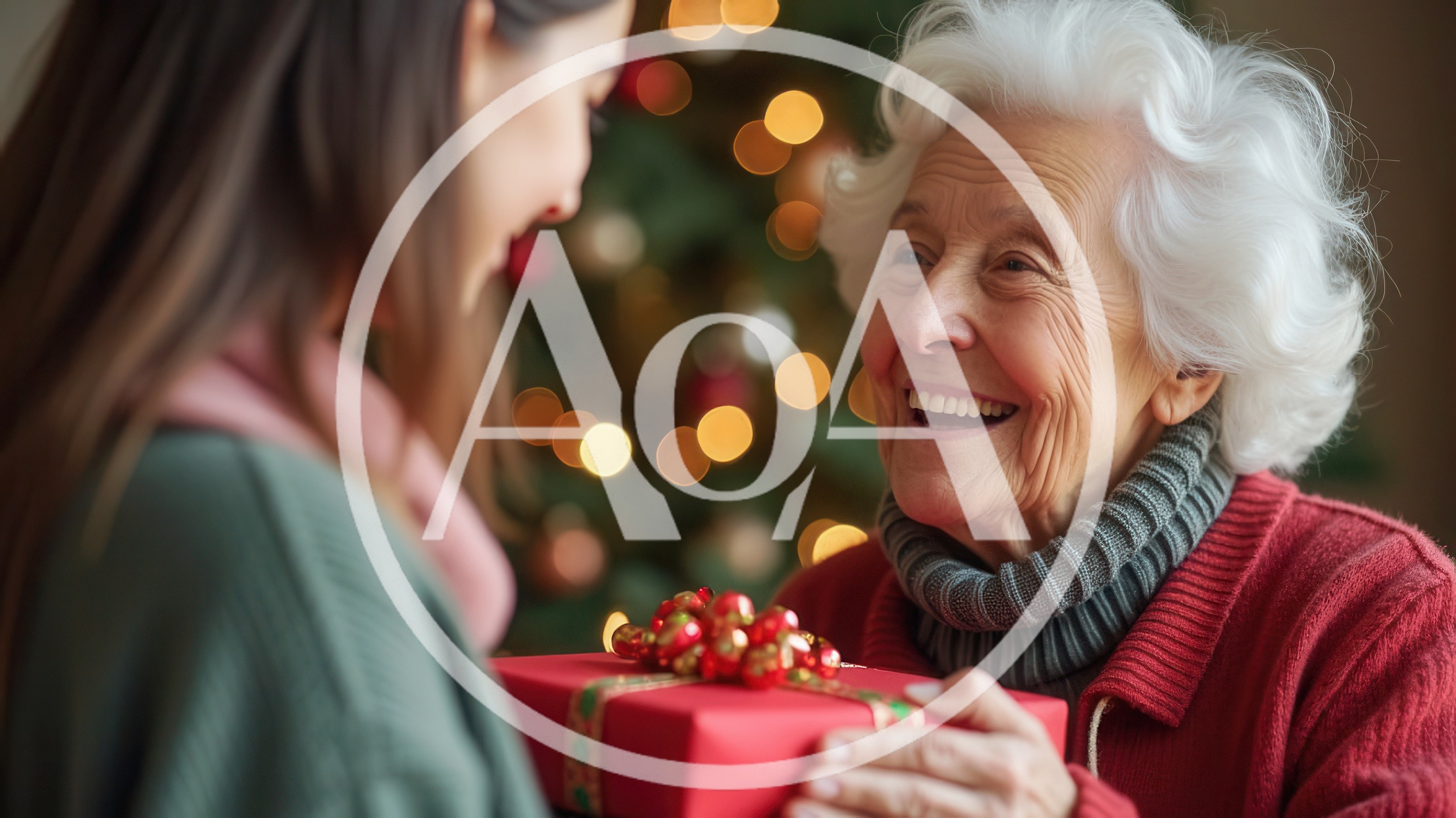 Granddaughter Giving Christmas Gift To Grandmother