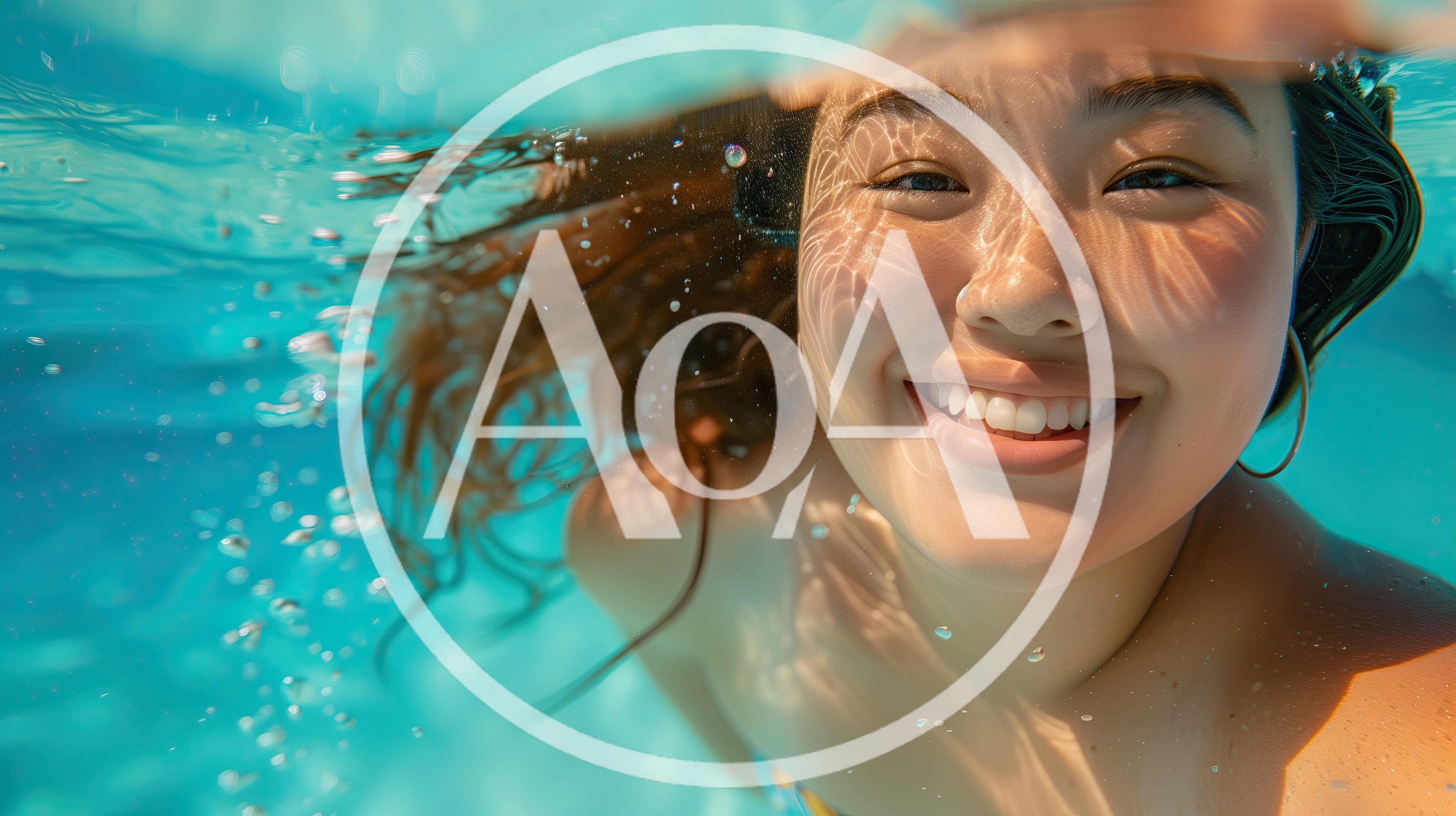 Young Woman Smiling Underwater In A Swimming Pool