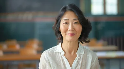 Portrait Of A Mature Asian Female Teacher In Classroom