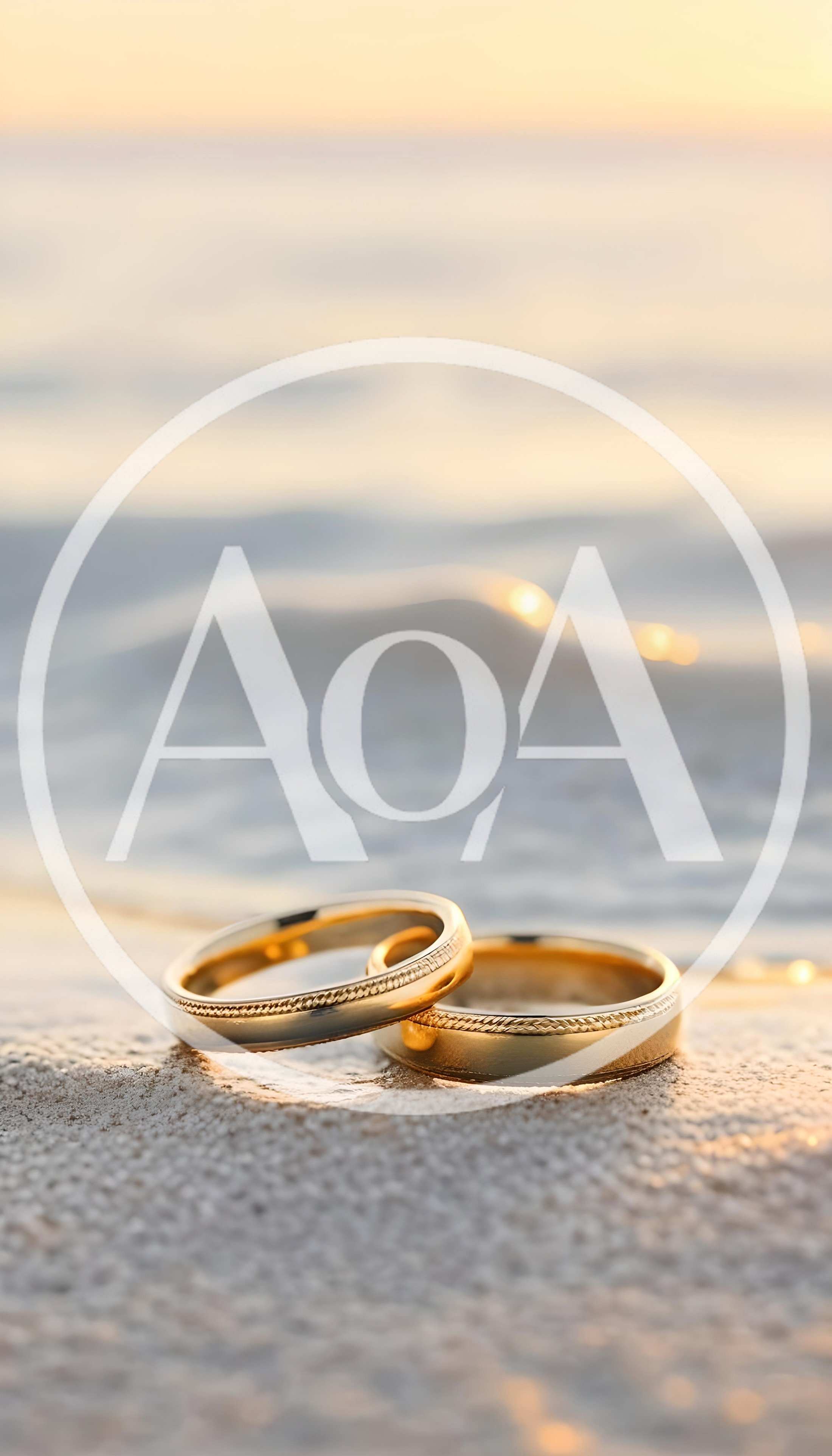 Two Gold Wedding Rings Resting On Sandy Beach