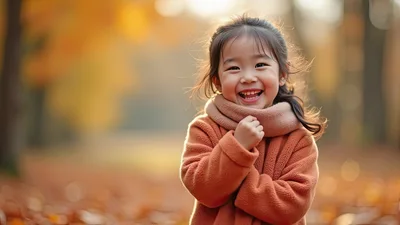 Happy Young Girl Laughing in Autumn Park