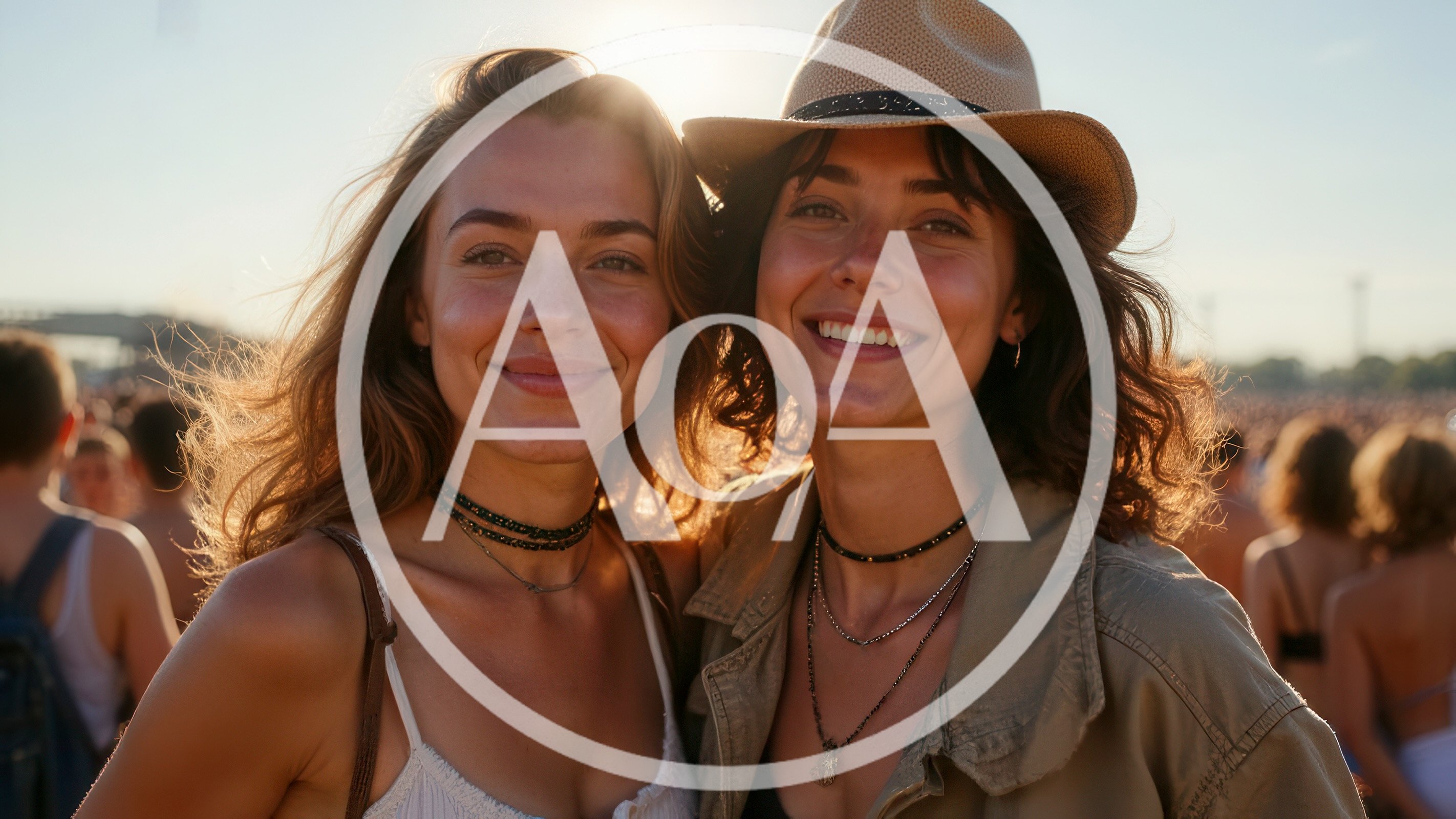 Two Young Women Smiling Together at an Outdoor Music Festival