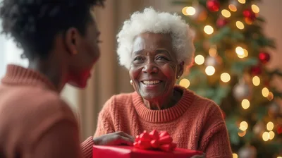 Senior Woman Receiving A Christmas Gift From Her Daughter