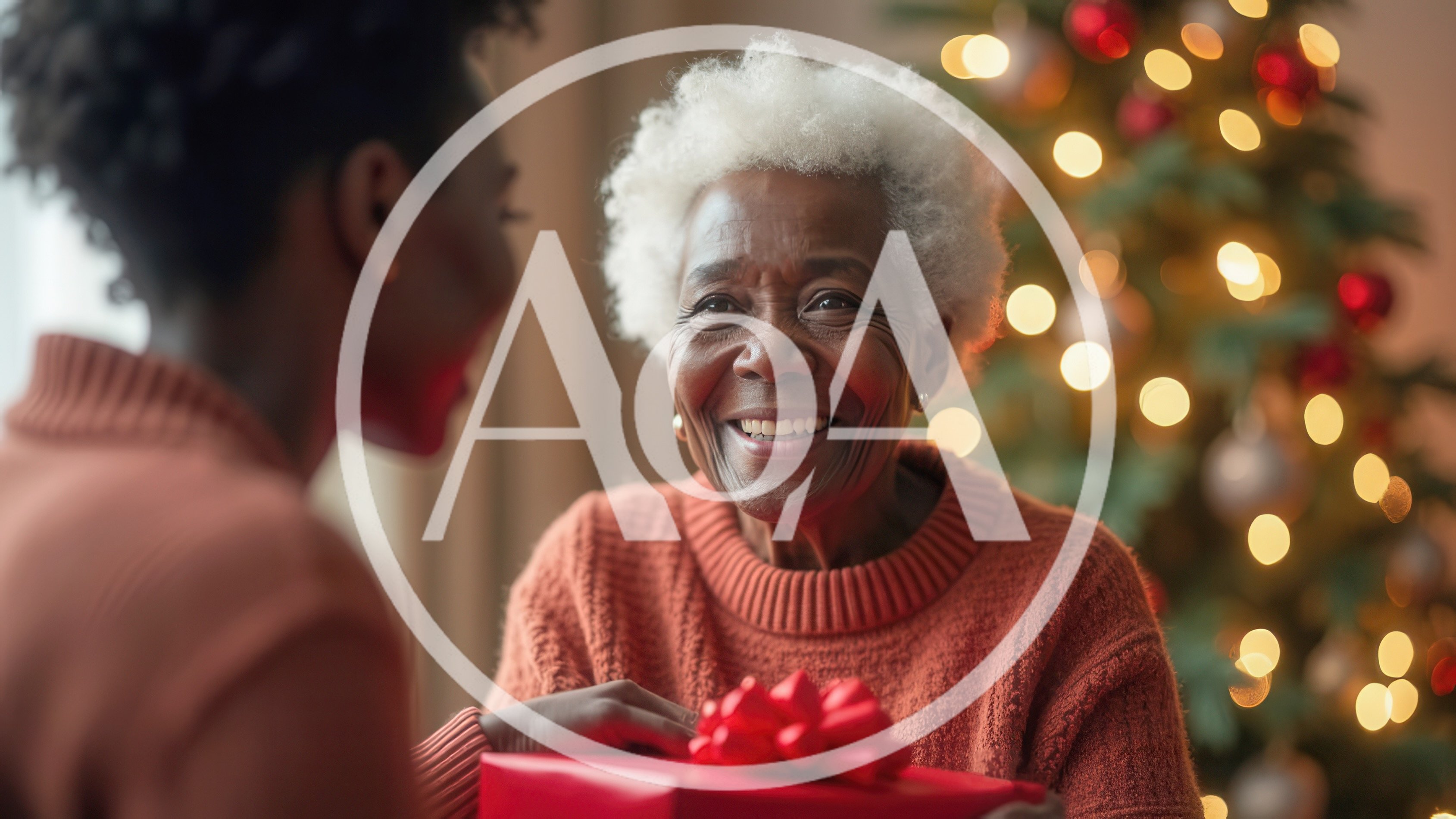 Senior Woman Receiving A Christmas Gift From Her Daughter