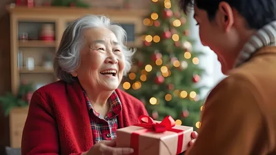 Grandson Giving Christmas Gift To Grandmother