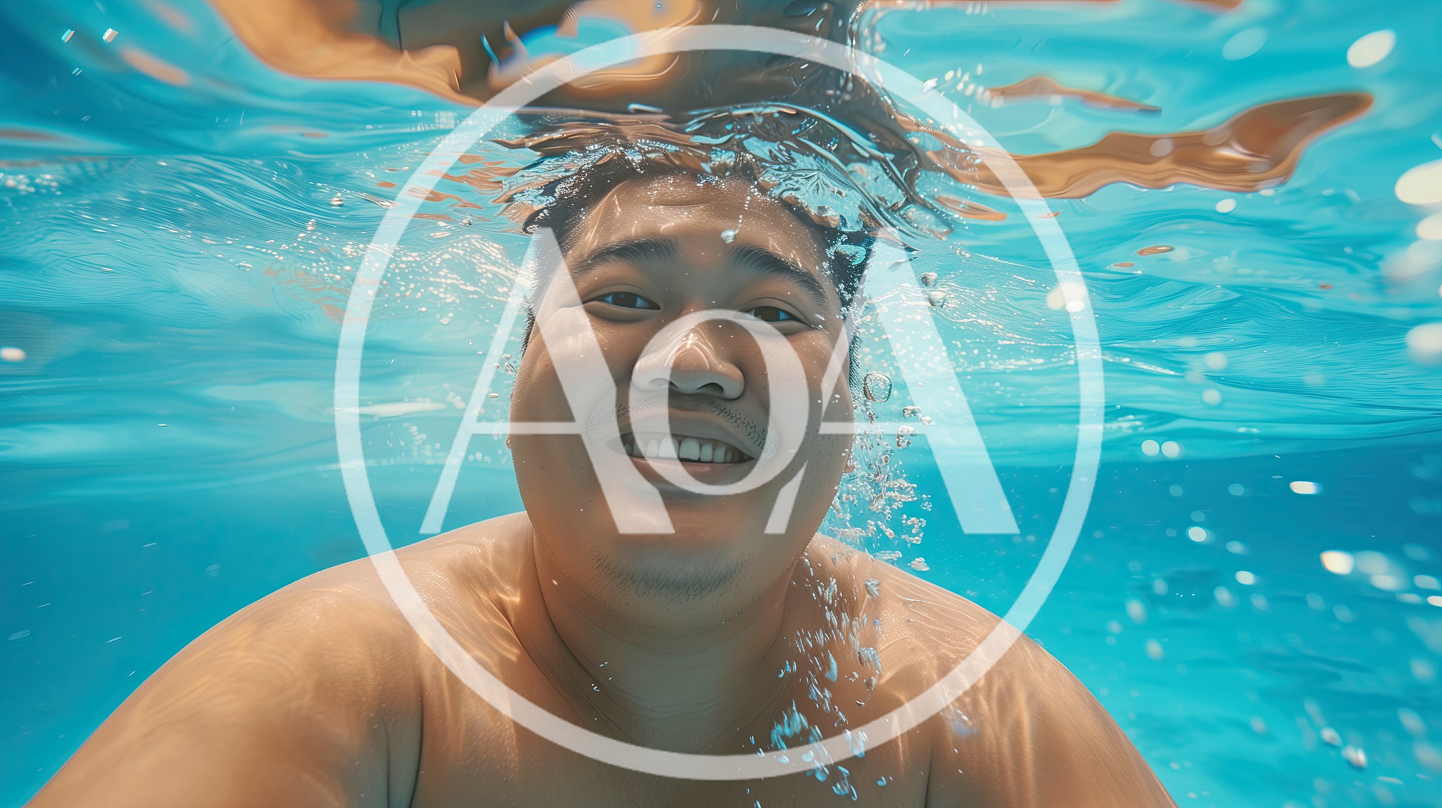 Asian Man Smiling Underwater In A Swimming Pool