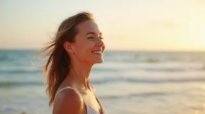Happy Young Woman Smiling On Beach At Sunset