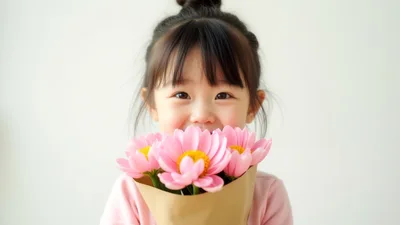 Little Girl Holding A Bouquet Of Pink Flowers