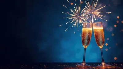 Two Champagne Flutes Toasting Against Fireworks Background