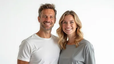 Portrait Of A Smiling Couple Against White Background