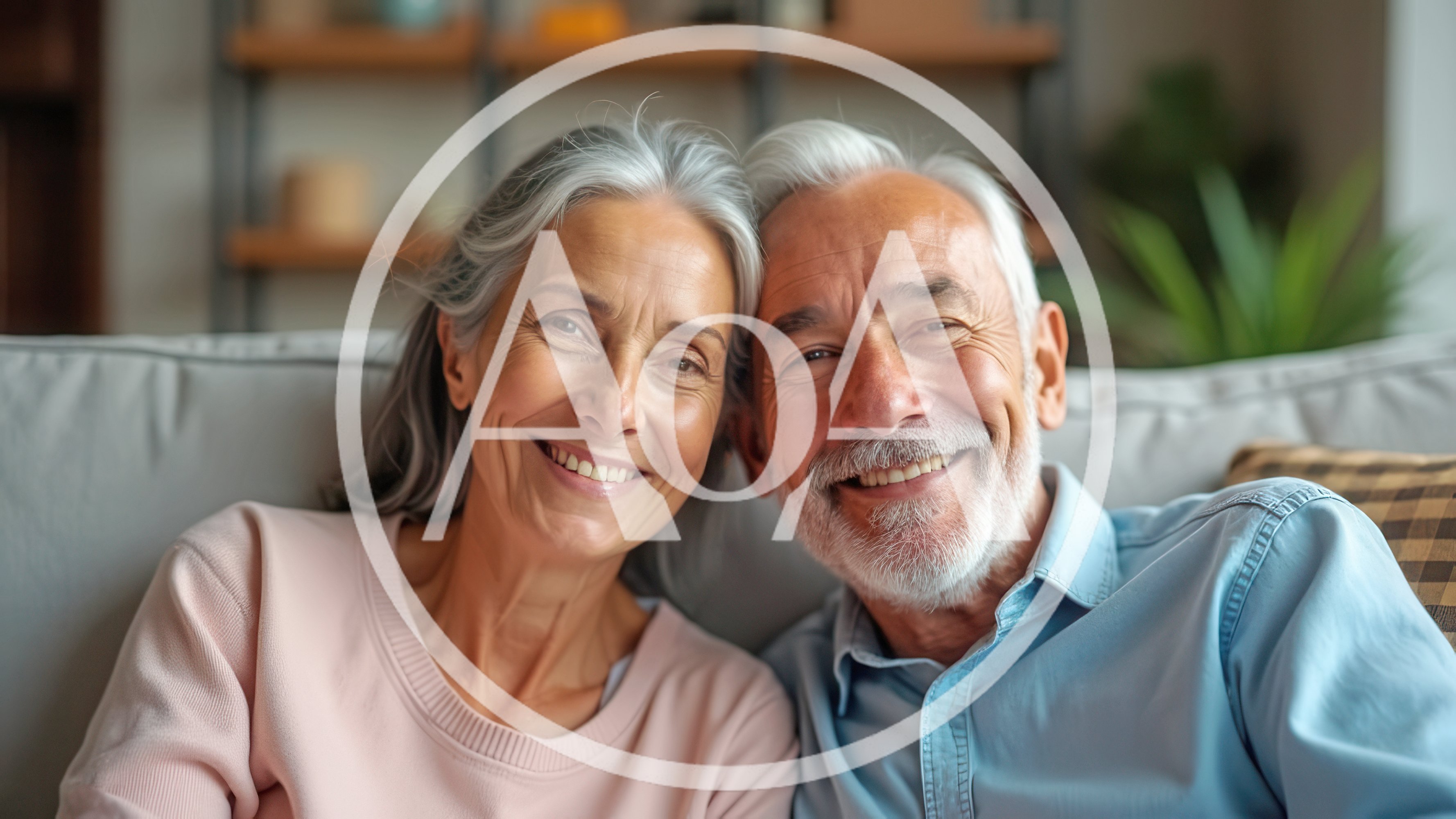 Happy Senior Couple Smiling Together On Sofa