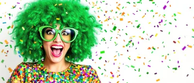 Excited Woman With Green Afro Wig And Confetti