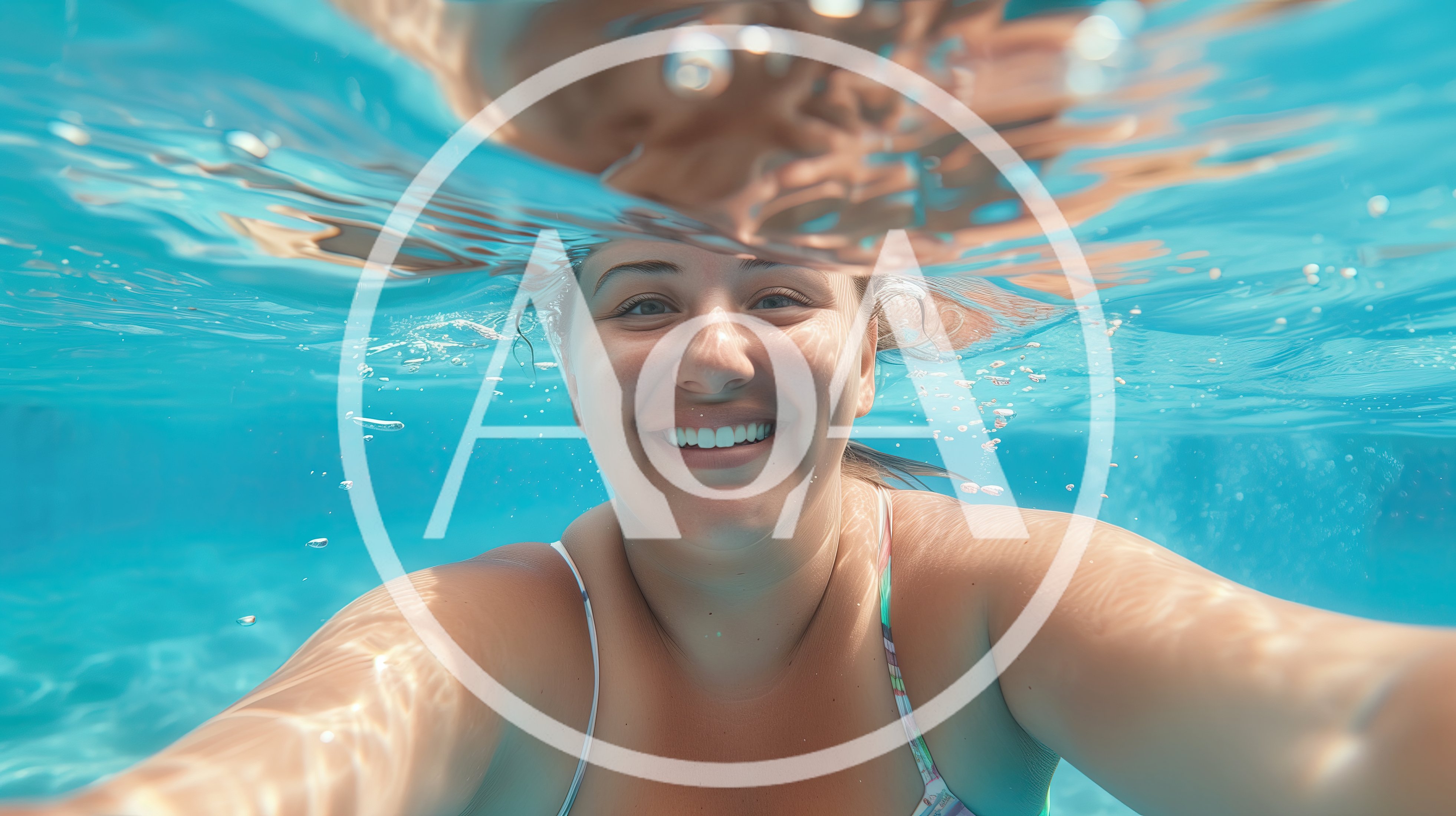 Young Woman Smiling Underwater In A Swimming Pool