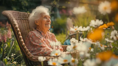 Elderly Woman Relaxing In A Wicker Chair Outdoors