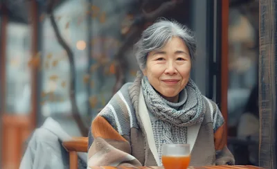 Senior Asian Woman Enjoying Tea At A Cafe