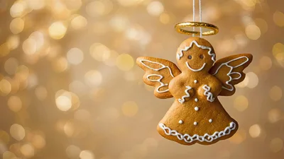 Gingerbread Angel Cookie Ornament Against Golden Bokeh Background