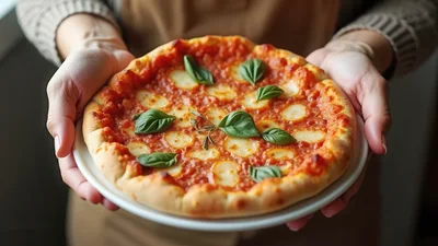 Person Holding A Freshly Baked Margherita Pizza