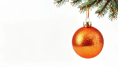 Orange Glittery Christmas Ornament Hanging From Pine Branch