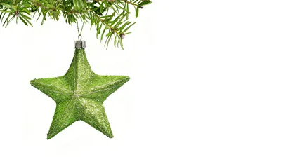 Green Glittery Star Ornament Hanging From Pine Branch