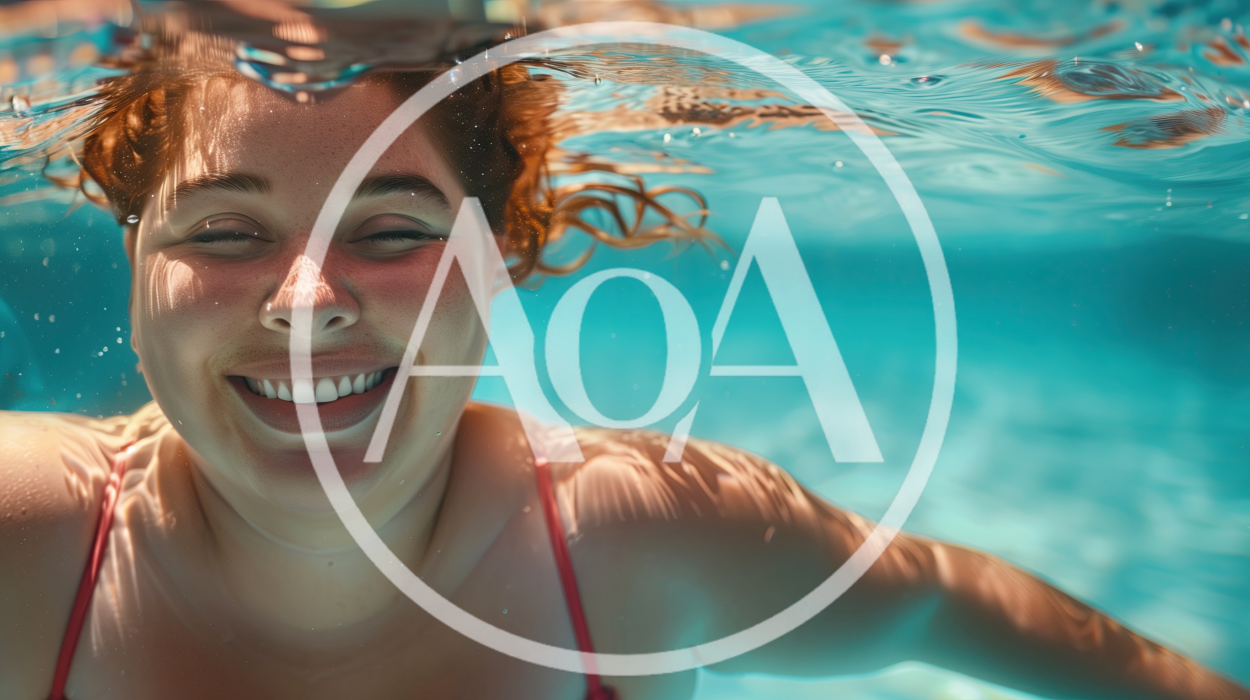 Young Woman Smiling Underwater In A Swimming Pool