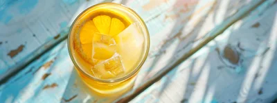 Glass Of Refreshing Orange Juice With Ice And Lemon