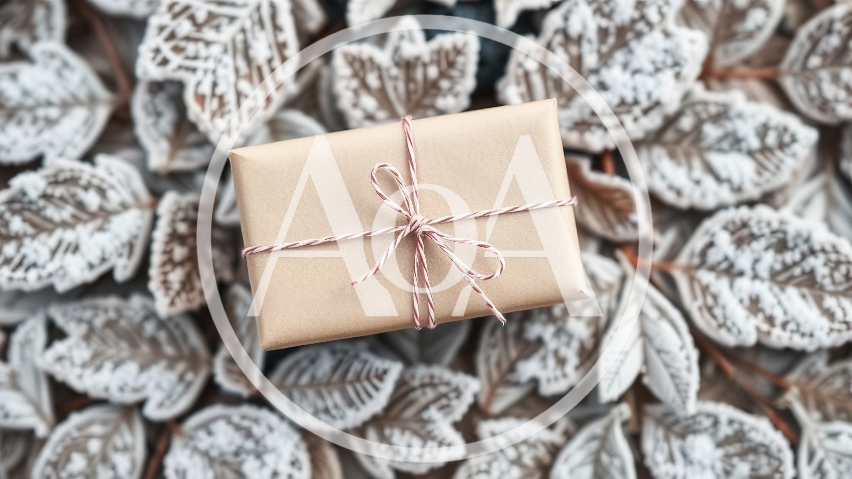 Gift Box Wrapped In Brown Paper On Frosted Leaves